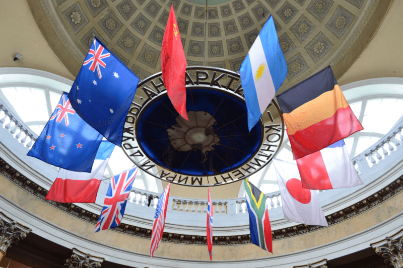 A shot of a ceiling with multiple flags including Australia, UK, Romania, and France.